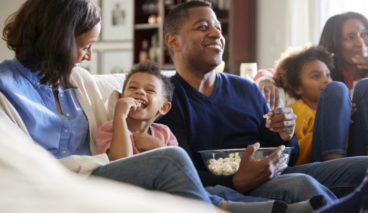 A family laughing together during movie night